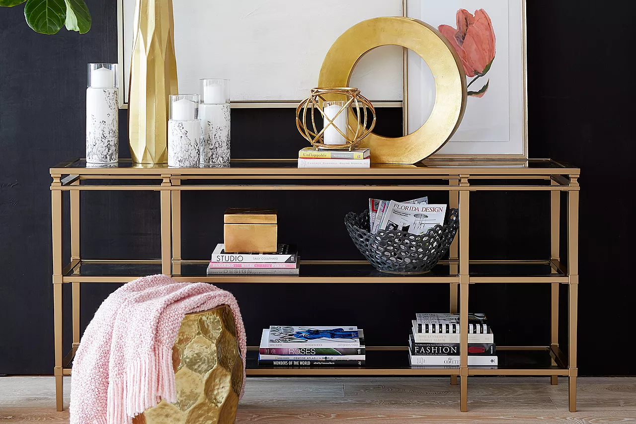 The Amani glass and gold finish sofa table in room scene.